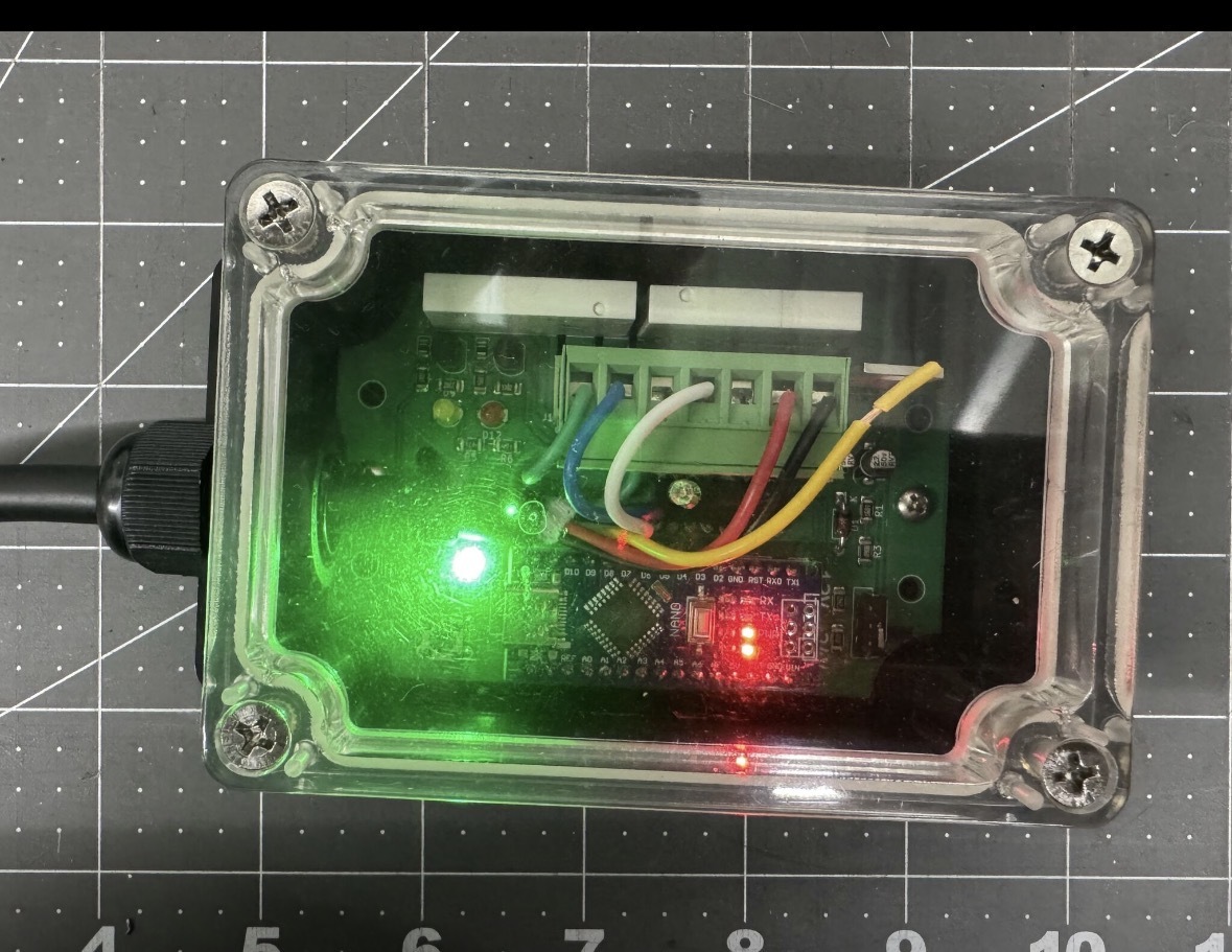 HorkusFlux battery monitor and battery saver electronics in a clear industrial enclosure