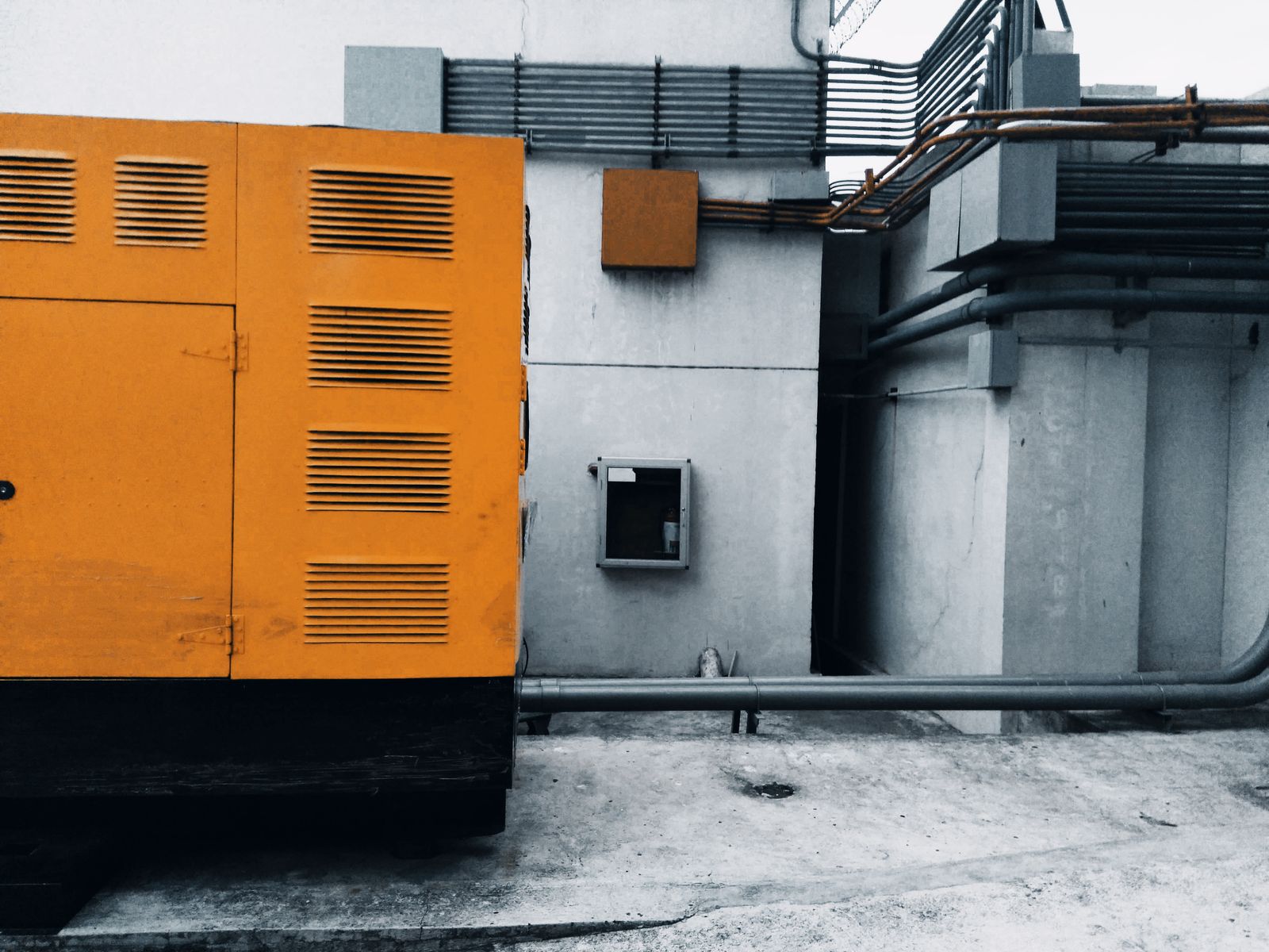 Industrial standby generator installed beside a commercial building